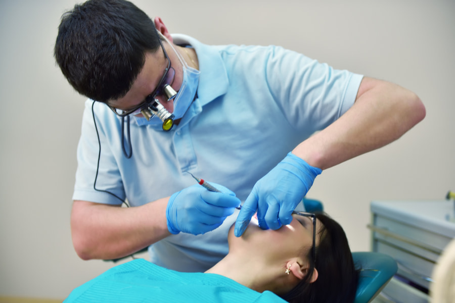 dentist placing a dental crown on a patient